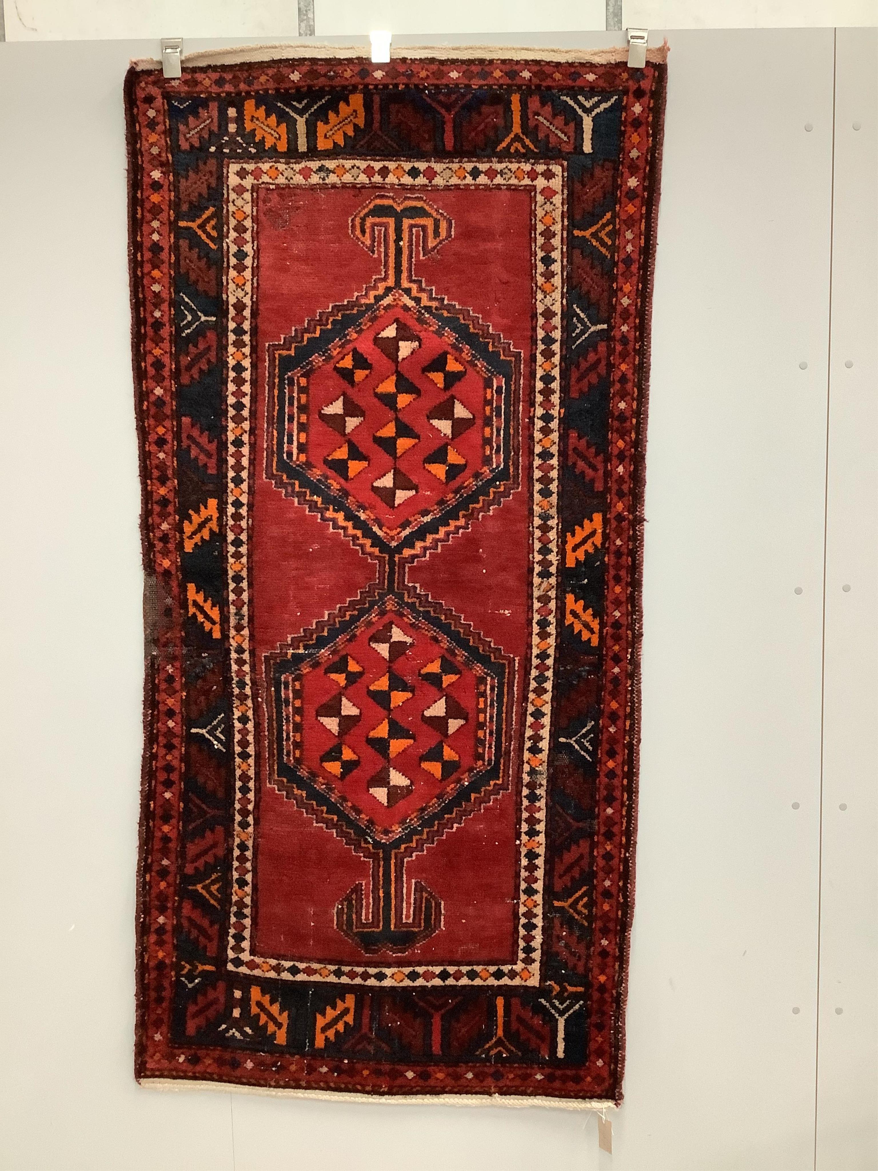 A Kazak style red ground rug, (moth damage) and a Turkish red ground rug, larger 200 x 98cm. Condition - poor to good